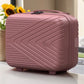 Pink textured suitcase on a surface with a blurred background